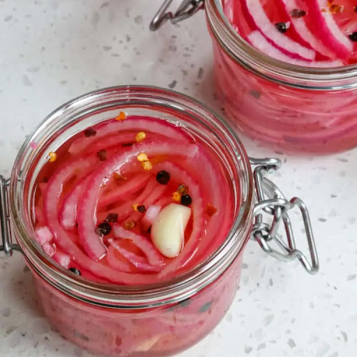 Quick pickled red onions are so easy to make, and they add flavor and texture to so many dishes. Try them on burgers, brats, sandwiches, burritos, tacos, casseroles, and so much more.