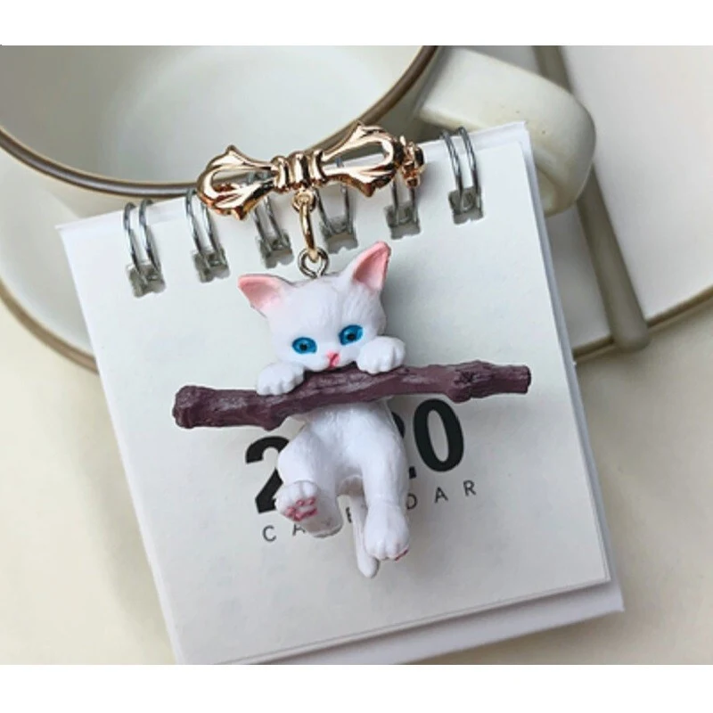 Adorable small Japanese style cat 3D brooch holding branches. Creative three-dimensional badge, a lovely accessory for a