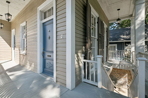 Front porch with blue door in this luxury property for sale in New Orleans ($699,000)