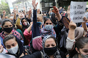 People protest outside the United Nations High Commissioner for Refugees (UNHCR) office to urge the international community to help Afghan refugees, in New Delhi, India, August 23, 2021. 