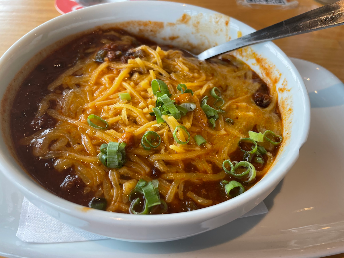 Bidon Chili with spicy chiles, ground bison, black, pinto & kidney beans, topped with cheddar & green onion