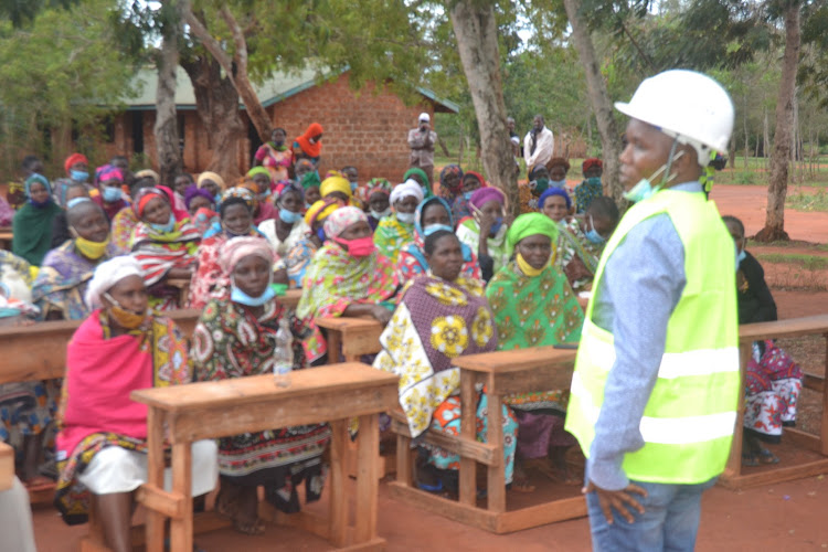 Ganze MP Teddy Mwambire addresses parents at Madamani primary school when he launched a classrooms project