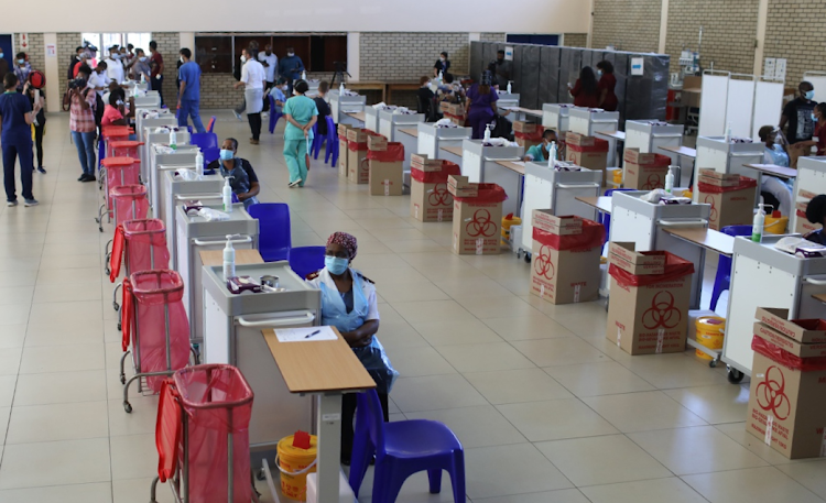 Healthcare workers at Covid-19 vaccine workstations at Chris Hani Baragwanath Hospital in Soweto, Johannesburg. The vaccine programme was disrupted in many areas in KwaZulu-Natal and Gauteng during last month's unrest and looting. File photo.