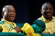 President of South Africa Jacob Zuma sits next to his deputy Cyril Ramaphosa at the 54th National Conference of the ruling African National Congress (ANC) at the Nasrec Expo Centre in Johannesburg, on December 16, 2017.