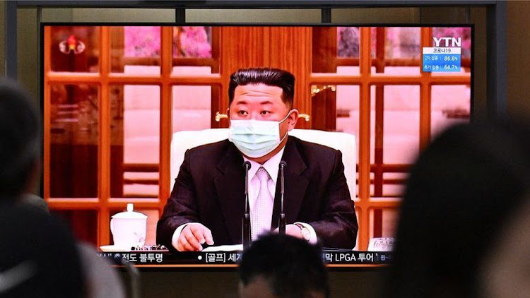 North Korean leader Kim Jong Un appeared in a face mask on television for the first time on Thursday to order nationwide lockdowns