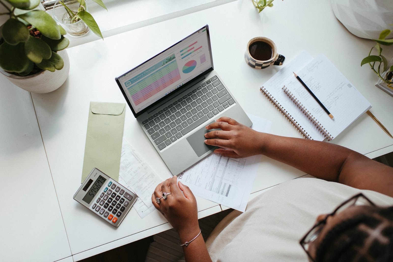 [Alt. Text: A picture of a business owner on her computer reviewing quarterly growth before meeting with a business consultant at Double Iron Consulting.]