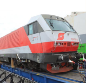 Tanzania's electric wagon being loaded on its tracks.