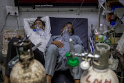 Patients suffering from Covid-19 receive treatment in the casualty ward in Lok Nayak Jai Prakash Hospital in New Delhi.