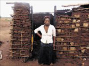 DESTITUTE: Merriam Nukeri outside her family's mud house that was burnt down. Pic. Moyahabo Mabeba. 11/08/2009.© Sowetan.