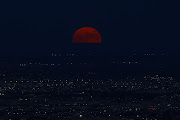 A super moon, known as the Blue Moon, rises above Ciudad Juarez, Mexico August 30, 2023. 