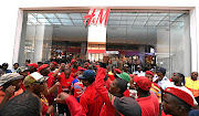 EFF members protest in front of the H&M store at the Mall of Africa in Midrand, Johannesburg. Party members have   vandalised  H&M stores after an advert with a black  boy wearing a hoodie  with 'coolest monkey in the jungle' written on it sparked  an outcry.  / Felix Dlangamandla / Gallo Images