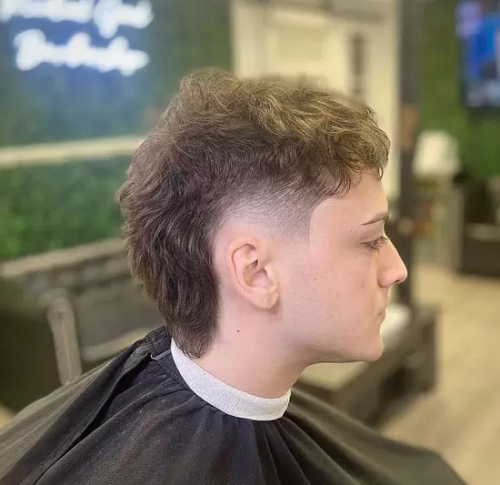 Man in the salon  shows off his wavy fade