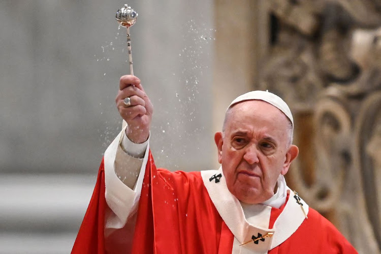 Pope Francis blesses attendees as he celebrates Palm Sunday behind closed doors in St. Peter's Basilica mass on April 5, 2020 in The Vatican, during the lockdown aimed at curbing the spread of Covid-19.