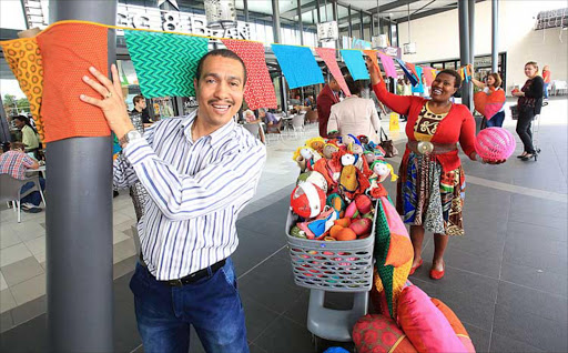 LOCAL IS LEKKER: Vincent Park general manager, Joseph Parsley, hangs decorations made by East London and Queenstown women, helped by Zoë Voyi Picture: SINO MAJANGAZA