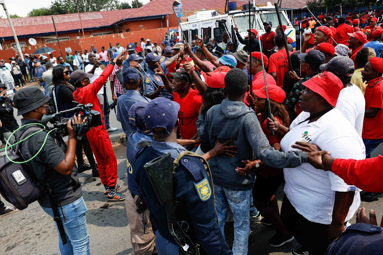 EFF supporters gather outside the Dobsonville police station in Soweto to support Victor Ramerafe who opened a case of assault, intimidation and house-breaking against Operation Dudula leader Nhlanhla Lux. Photo Thulani Mbele