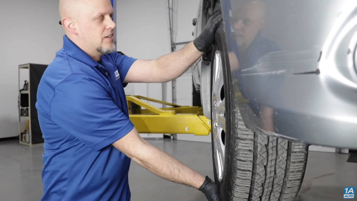 Testing the wheel hub bearings by grabbing the tire from the 12 and 6 o'clock positions