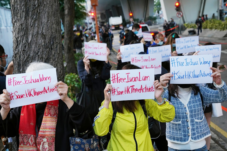 Supporters hold up signs after the sentencing of pro-democracy activists Joshua Wong, Agnes Chow and Ivan Lam, at West Kowloon Magistrates' Courts in Hong Kong, China, December 2 2020. Picture: REUTERS/LAM YIK