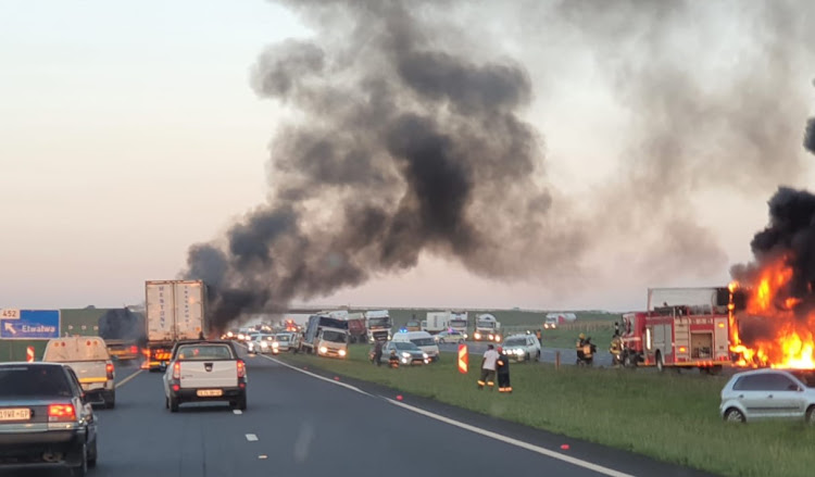 The N12, near the Etwatwa off-ramp, had to be closed to traffic after two trucks were set alight on Wednesday morning.