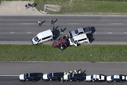 Law enforcement personnel investigate the scene where the Texas bombing suspect blew himself up on the side of a highway north of Austin in Round Rock, Texas, U.S., March 21, 2018. 