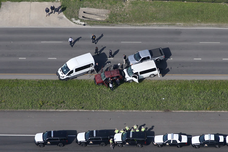 Law enforcement personnel investigate the scene where the Texas bombing suspect blew himself up on the side of a highway north of Austin in Round Rock, Texas, U.S., March 21, 2018.