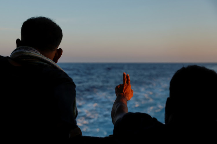 A migrant gestures at the Geo Barents migrant rescue ship operated by Medecins Sans Frontieres as it makes its way to Italy after the rescue of 61 migrants on a wooden boat in international waters off the coast of Libya in the central Mediterranean Sea. Picture: DARRIN ZAMMIT LUPI