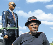 Lebohang Khitsane with a statue of Robbie Malinga. There was drama at the memorial held for the businessman at the weekend. File photo.