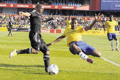 A file photo of Dikgang Mabalane (L) and Method Mwanjali (R) fight for possession during a match between Mamelodi Sundowns and Orlando Pirates.