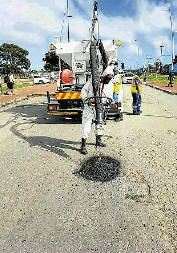 PICTCHING IN: Locals from community organisation, Makana Revivie, have hired a Jet-Patcher machine and are doing their bit to fill up the potholes to which the city has become notorious for Picture: SOCIAL MEDIA