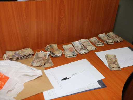 Some of the money recovered from four traffic cops arrested by the EACC for soliciting bribes from motorists on Nairobi-Nakuru highway, March 22, 2017. /RITA DAMARY