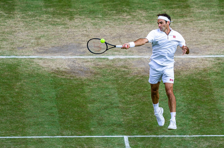 Roger Federer of Switzerland plays a forehand in his men's singles semifinal against Rafael Nadal of Spain at The Championships - Wimbledon 2019 at the All England Lawn Tennis and Croquet Club on July 12, 2019.