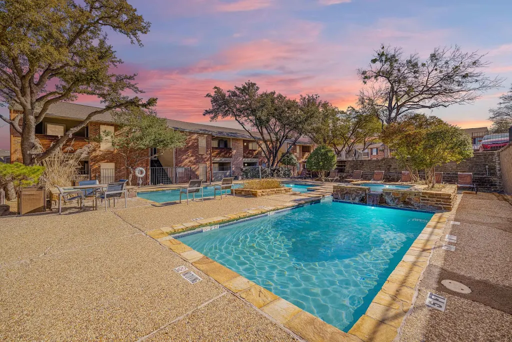 Westgate's swimming pool at dusk with sundeck featuring lounge chairs and outdoor seating