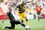 ADROIT: Kaizer Chiefs striker Bernard Parker avoids a tackle by 
      
       Orlando Pirates defender Rooi Mahamutsa during  their Carling Black Label Cup game  at Soccer City last weekend. 
      Photo: SIMPHIWE NKWALI