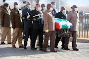 Pallbearers arrive with the casket of Andrew Mlangeni during the official funeral held at UJ Soweto campus on July 29 2020.
 