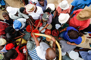 Damonsville residents queue for water in Brits.