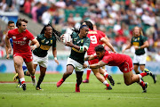 Branco du Preez of South Africa is tackled by Mike Fuailefau of Canada on day one of the HSBC London Sevens at Twickenham Stadium on June 2, 2018 in London, United Kingdom.