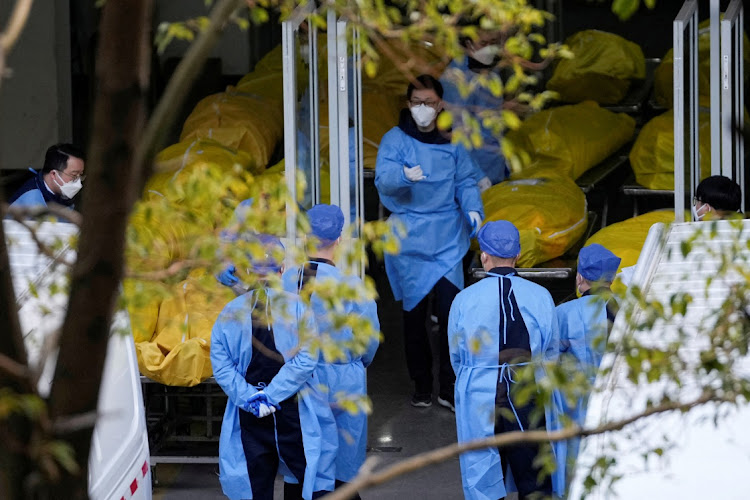 A staff member walks next to bodies in body bags at a funeral home in Shanghai, China, January 4 2023. Picture: REUTERS