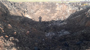 The crater caused by a blast after a truck transporting explosives caught fire.