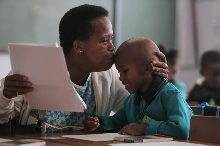 Bernadette Mekgoe shares a light-hearted moment with her grandson, Mokgwaro on his first day of school at Melpark Primary school in Melville, Johannesburg.