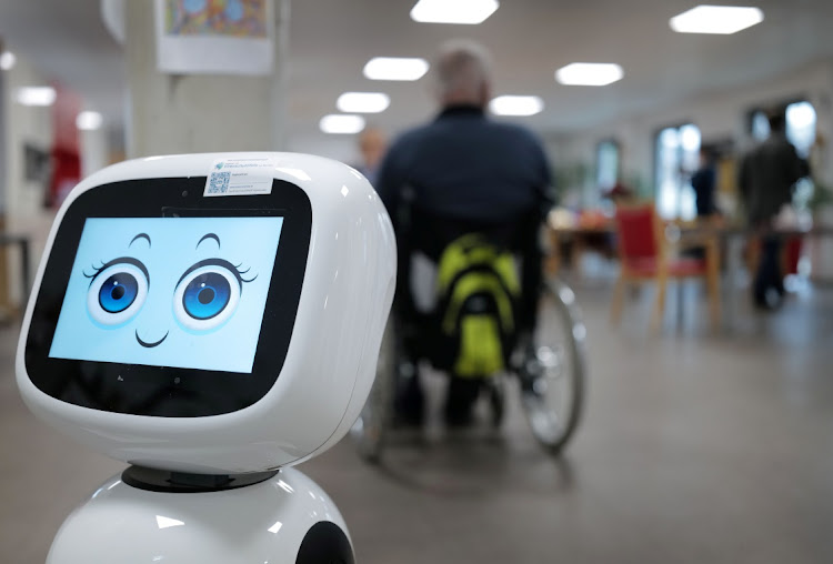 A robot sports a smile after checking whether a visitor is wearing a protective mask upon entering the day care center of German welfare organisation Caritas as the spread of the coronavirus disease (Covid-19) continues in Erlenbach, 50 km south of Frankfurt, Germany, November 25, 2020.