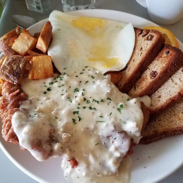 Chicken fried steak, eggs, potatoes and cinnamon raisin toast