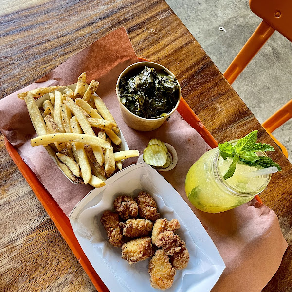 Adult chicken nuggets with fries - all fried in a dedicated GF fryer. Side of collard greens and a Mango Nojito. Delish!