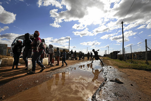 People from the settlement of Boikhutso collect water from a tanker in Lichtenburg. Clover has decided to close down SA's largest cheese factory in the town due to poor service delivery.