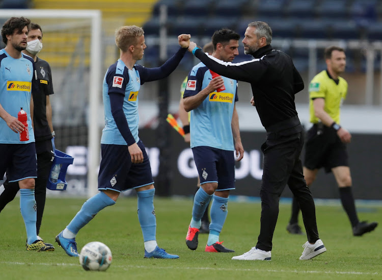 Moenchengladbach head coach Marco Rose with players after their match against Frankfurt