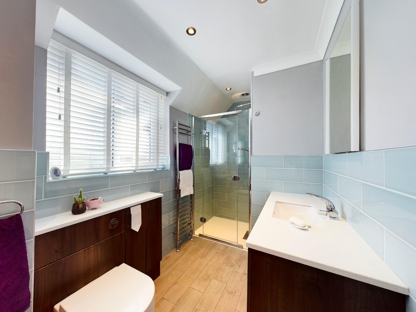 A bathroom with a tub sink and toilet  Description automatically generated with low confidence