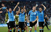 Uruguay's Luis Suarez, Jose Gimenez and team mates celebrate after the match.