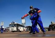 City health workers spray disinfectant at a bus terminus during a 21 day nationwide lockdown to limit the spread of coronavirus disease in Harare, Zimbabwe. File photo 
