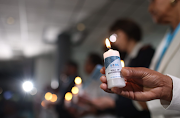 Nurses held flickering candles during a s service held in honour of their late colleagues who died during the Covid-19  pandemic.