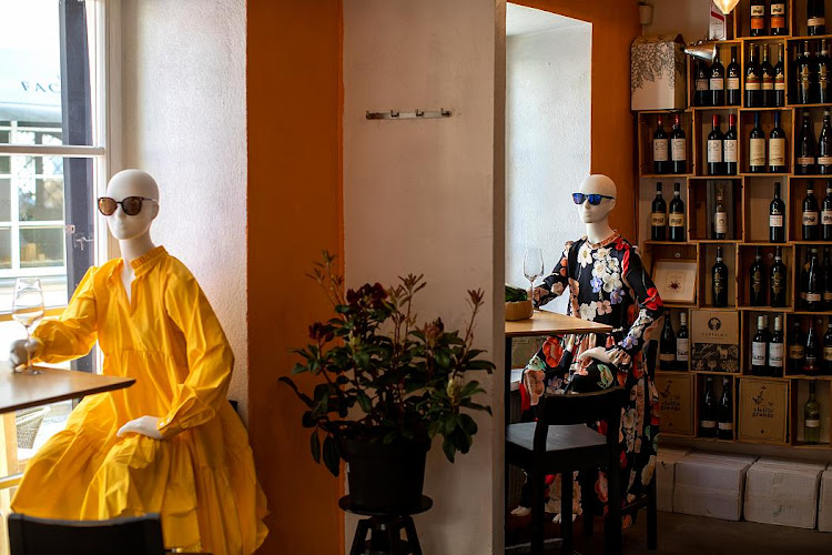 Mannequins are placed to help to assure social distancing at a restaurant in Vilnius, LithuaniaMindaugas Kulbis/AP Photo