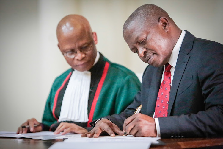 David Mabuza signs an Oath of Office as the Deputy President of the Republic of South Africa before Chief Justice Mogoeng Mogoeng.