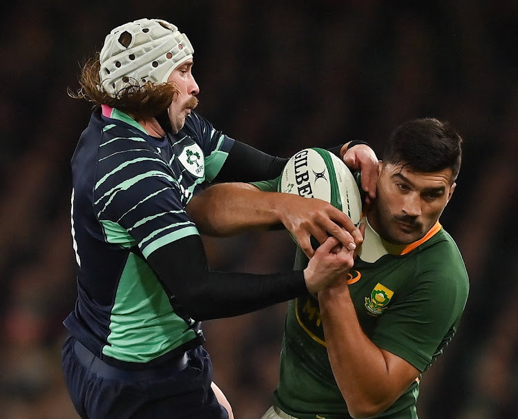 Mack Hansen of Ireland and the Springboks' Damian de Allende contest a dropping ball in their 2022 Outgoing Tour match at Aviva Stadium in Dublin on November 5 2022.